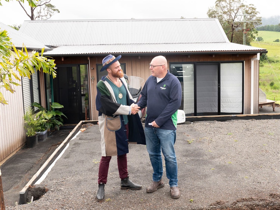 First-home owner Andre Stamatakakos shaking hands with Mayor Steve Krieg