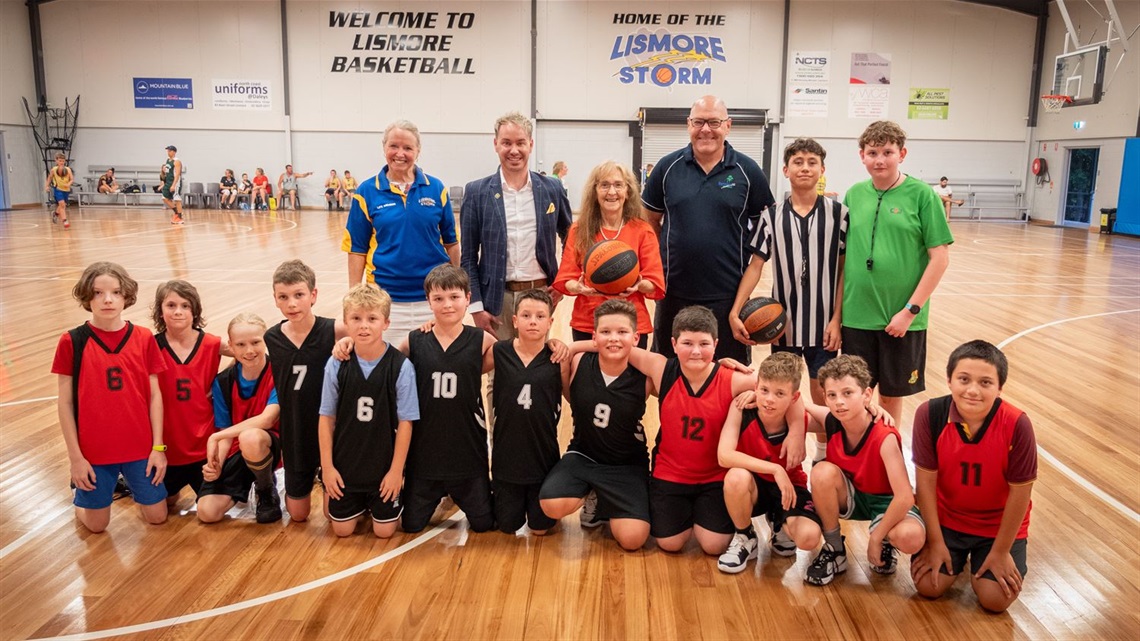 Mayor Steve Krieg and State Member for Lismore Janelle Saffin with a group of young basketball players.