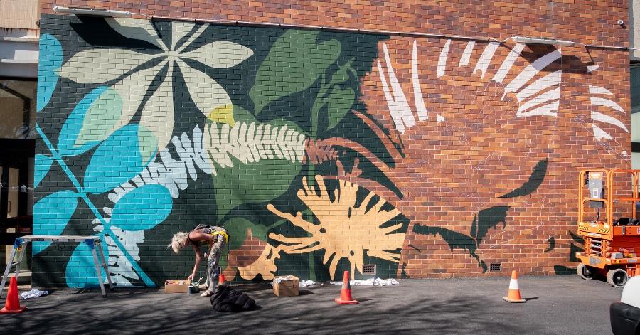 Kate Stroud painting the mural.