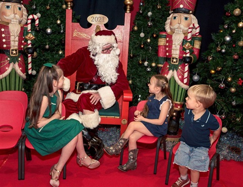 Santa with some kids around