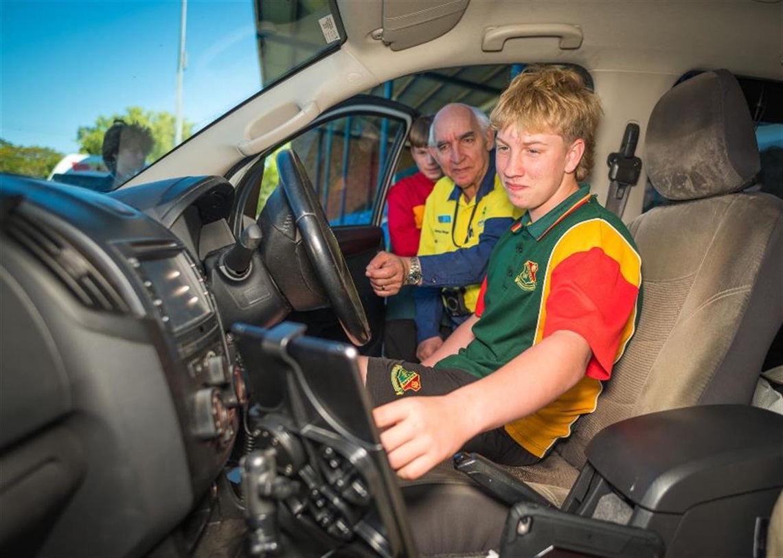 Students inspect the inside of a Council Ranger's vehicle