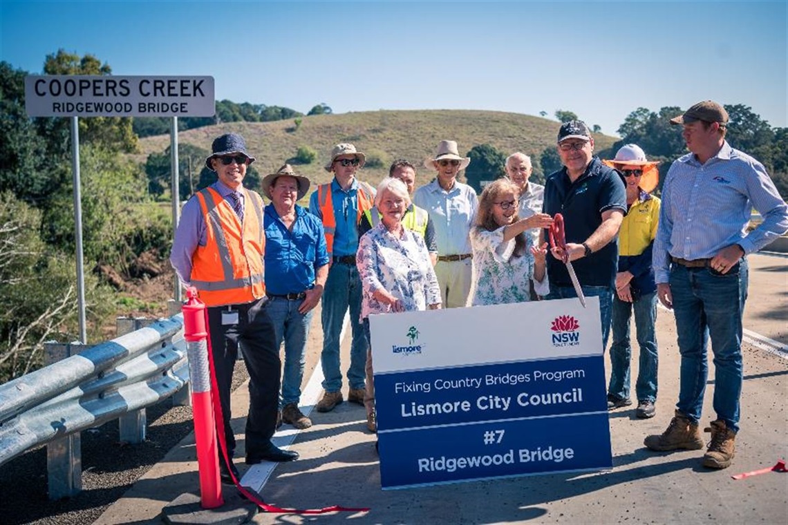 Mayor Steve Krieg and State Member for Lismore Janelle Saffin cut the ribbon, with Clunes local and Council's bridge crew looking on